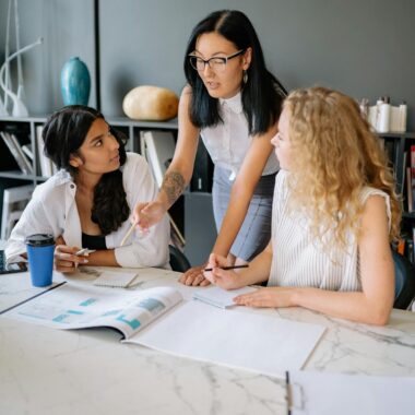 Women at the Meeting Table Having a Discussion